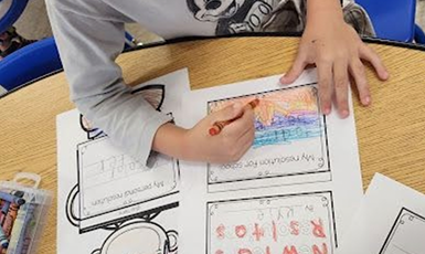  Child coloring a worksheet
